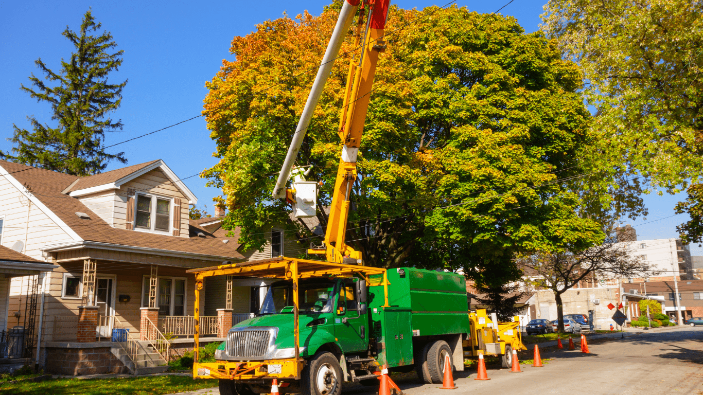 Professional tree services being provided by one of our boom trucks to a house in Madison, Ohio